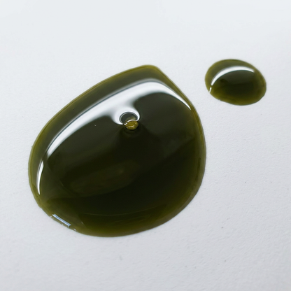 Green oil droplet on a white background